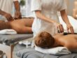 Hot stone massage, black couple and relax spa in skincare wellness, healthcare or stress management