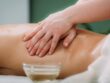 Massaging with massage oil, hands of a female massage therapist massaging a female client